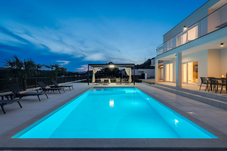 a large 47 m2 (10.5 m x 4.5 m) sparkling private pool at night