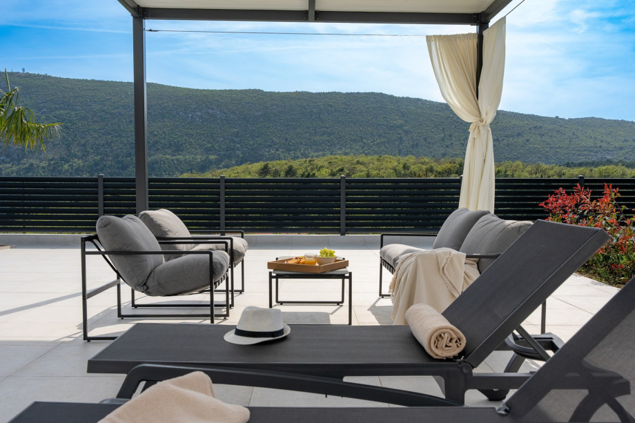 a covered lounge area by the pool
