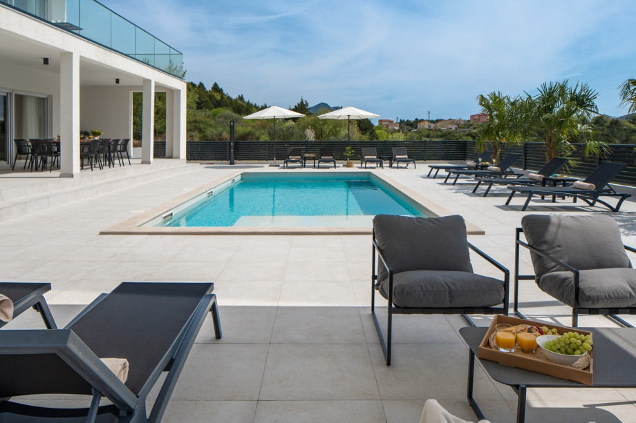 a covered lounge area by the pool