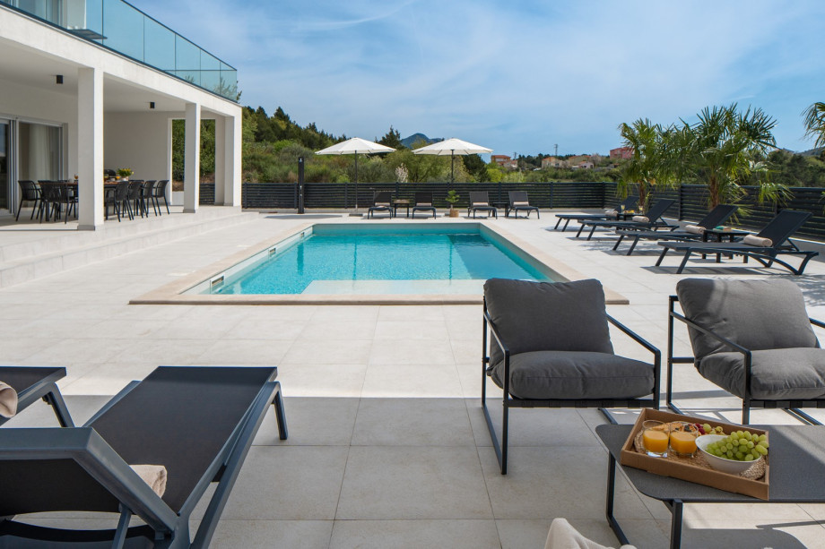 a covered lounge area by the pool