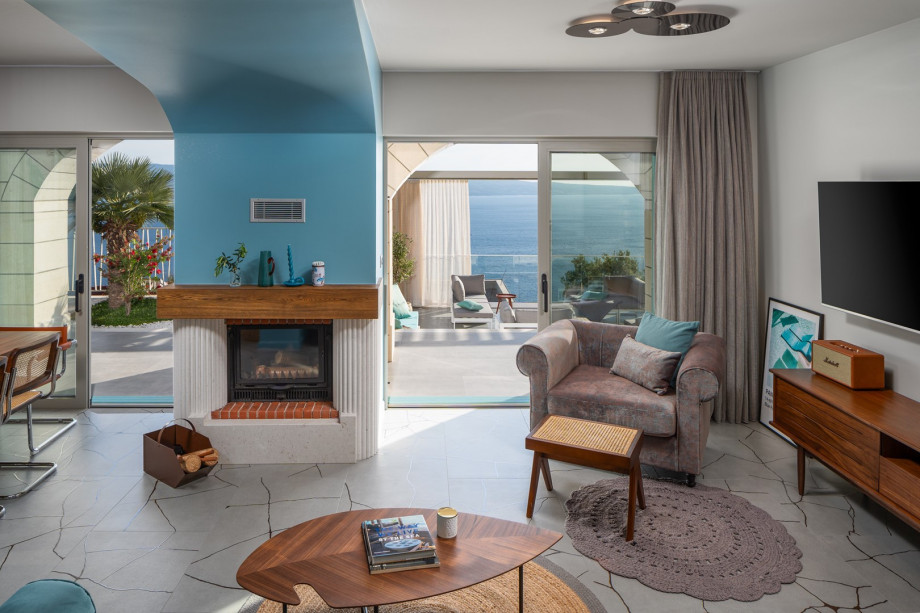 A cozy sofa with a television, and a fireplace for intimate evenings