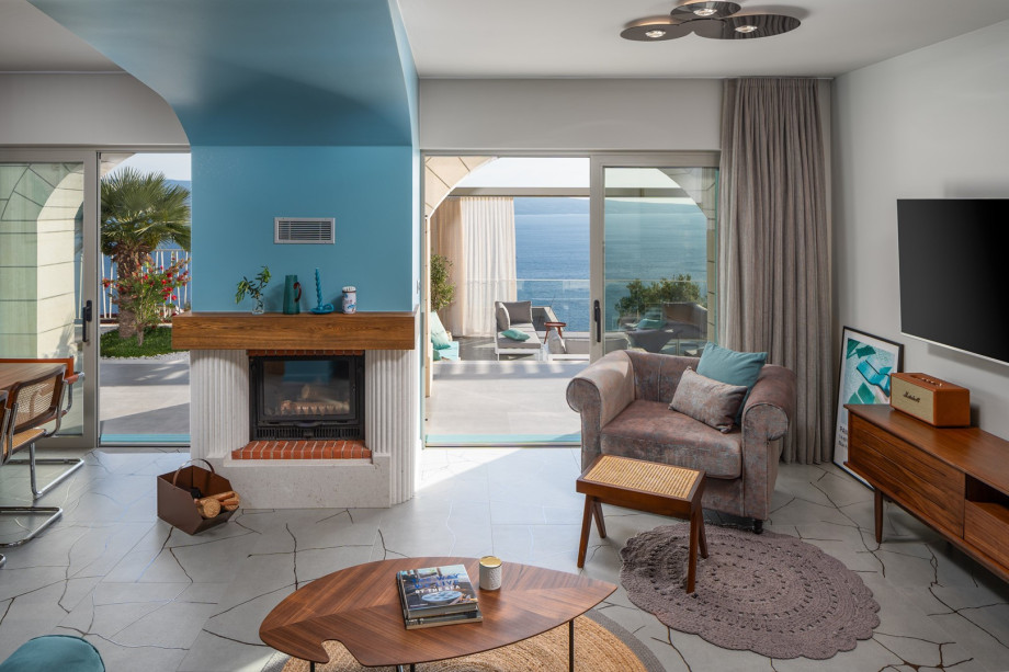 A cozy sofa with a television, and a fireplace for intimate evenings