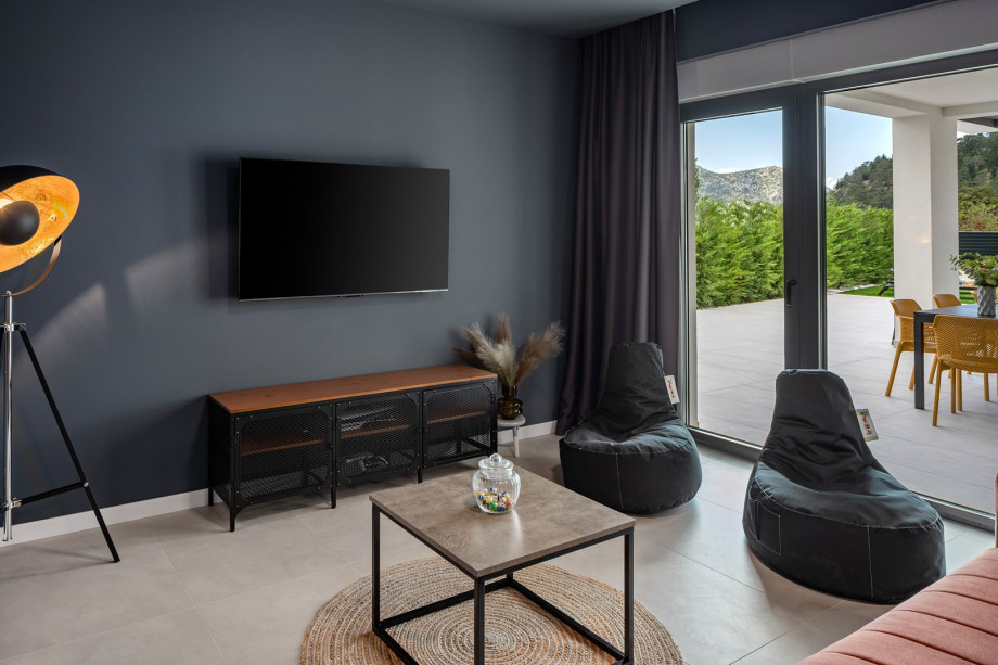 Media room with TV, PlayStation 5, AC, couch and foosball table