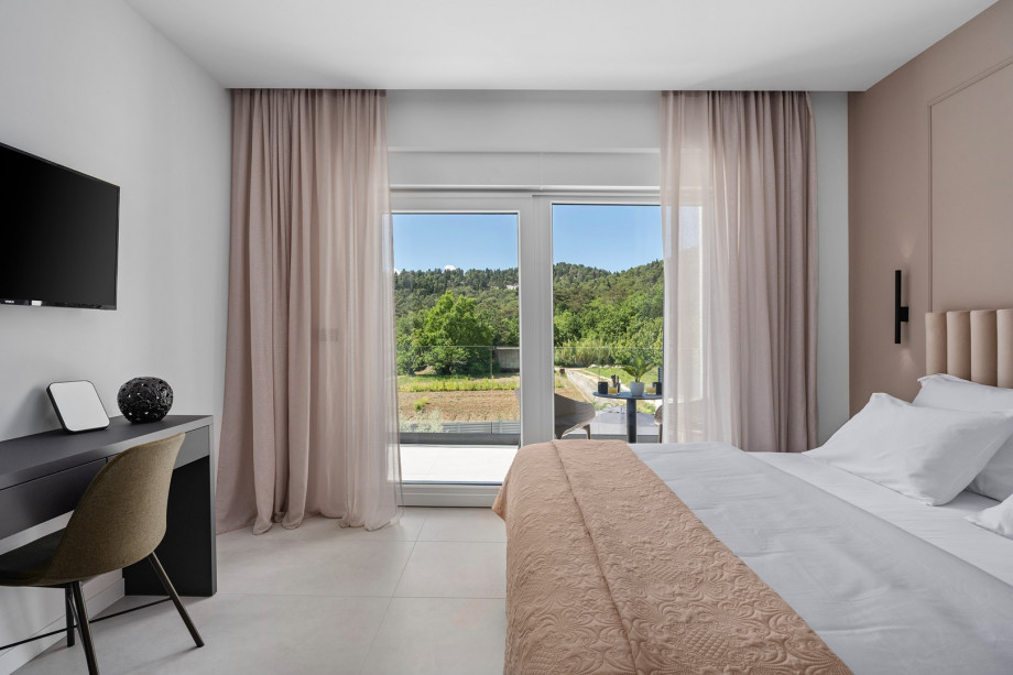 Bedroom NO1 with a king-size bed, A/C, TV, balcony overlooking the pool and surrounding landscape, and ensuite bathroom with a bathtub.