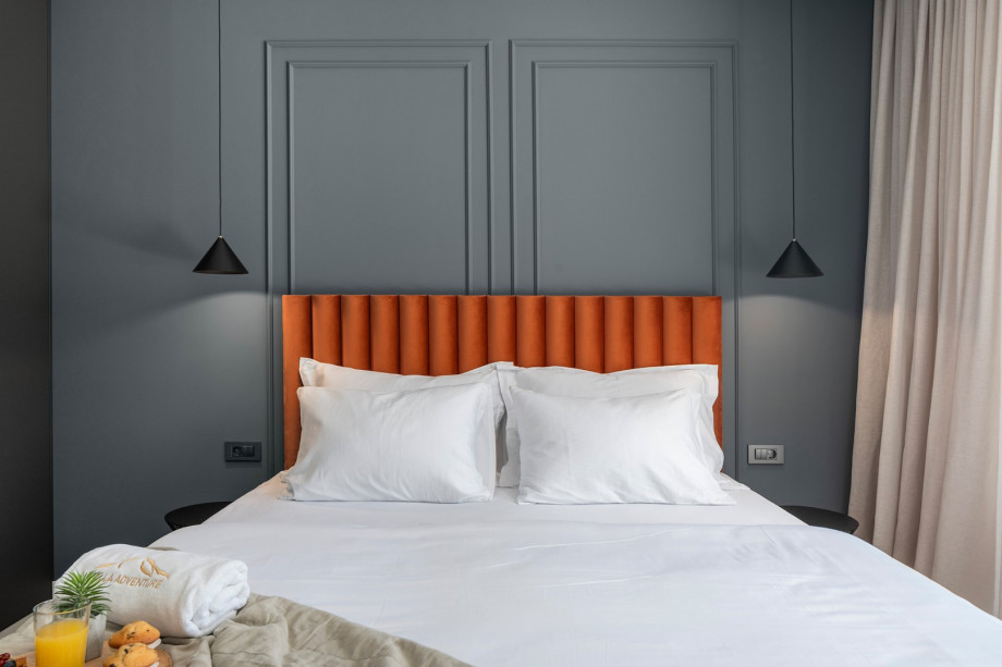 Bedroom NO2 with a king-size bed, A/C, TV, balcony overlooking the pool and surrounding landscape, and ensuite bathroom with a shower.