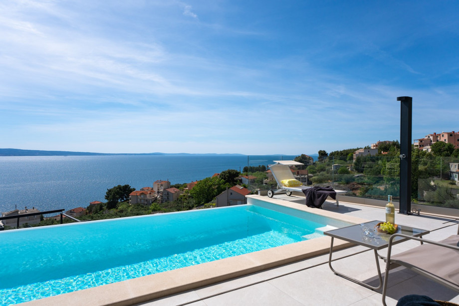 Three-bedroom Villa Sunshine with a heated pool, media room, and views of the sea