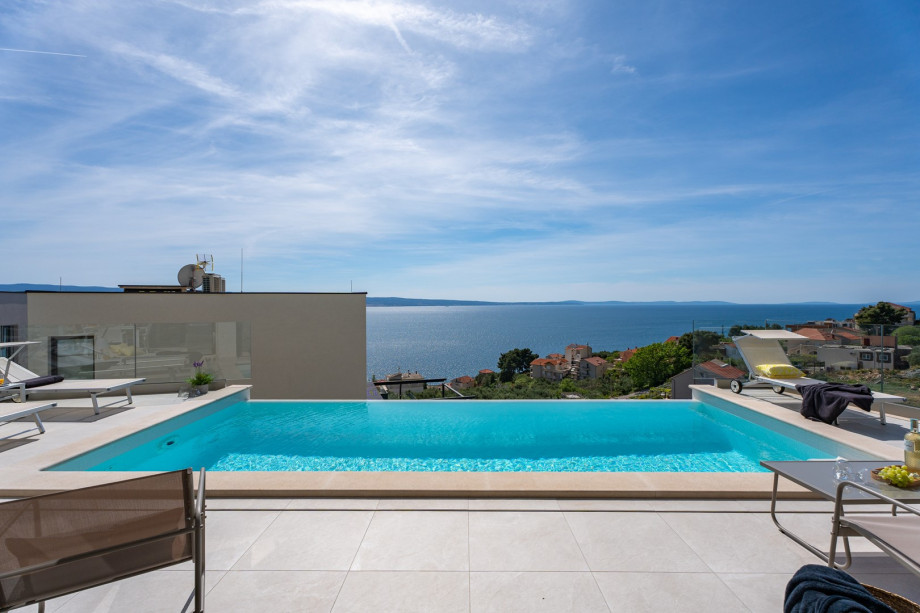 Heated 5-by-2,5-meter private pool and a sun deck area with deck chairs
