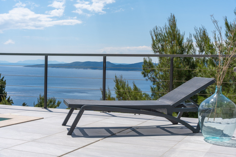 Private 32msq pool with 7 comfortable lounge chairs and an open sea view