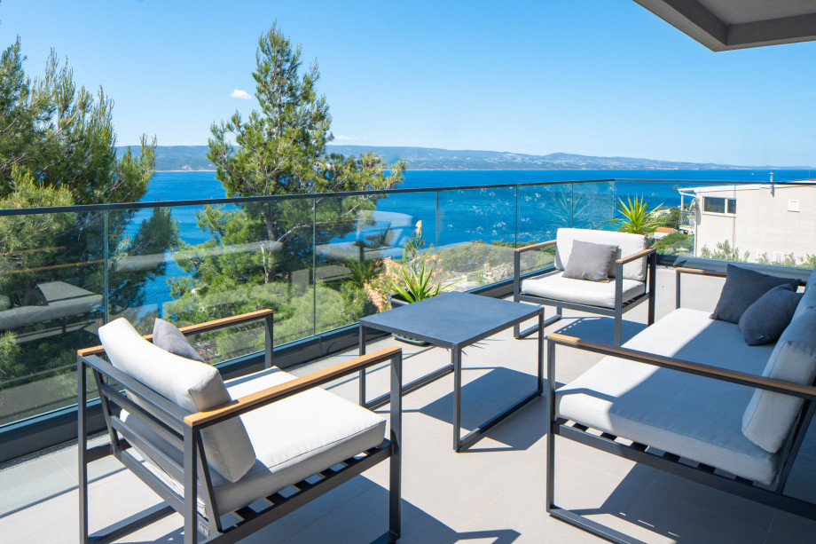 Covered lounge corner with amazing sea views, exit from living room