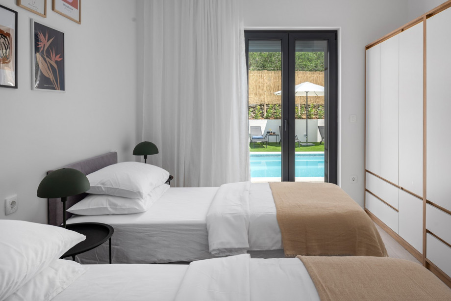 Bedroom NO2 (14sqm) with glass door toward the pool area, A/C, a TV, two single beds 90cm x 200cm that can connect into a king size bed.