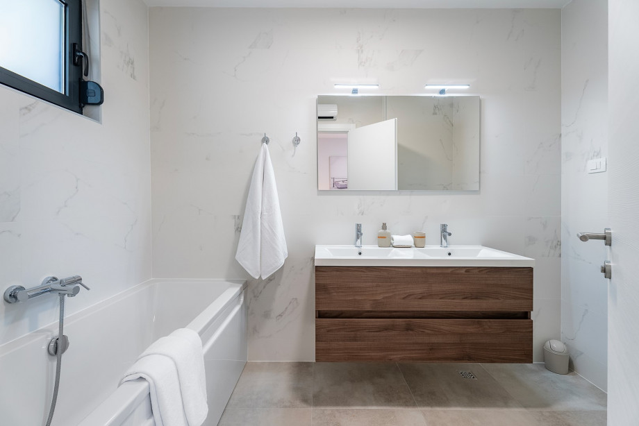 En suite bathroom with bathtub and a shower.