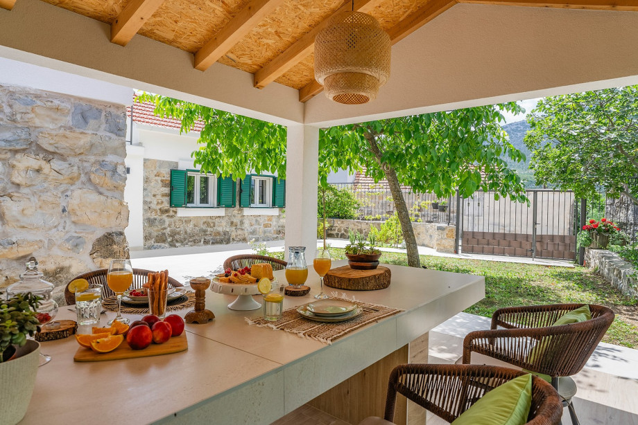 Covered outdoor dining area complete with an electric barbecue