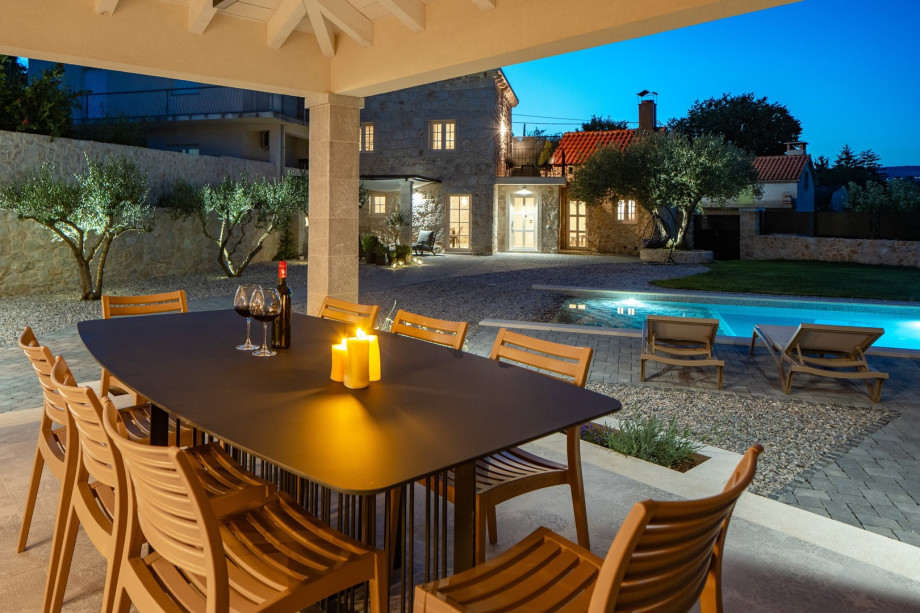 A covered dining area with a barbecue