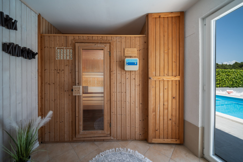 Finnish sauna with a shower and a separate toilet, next to the pool