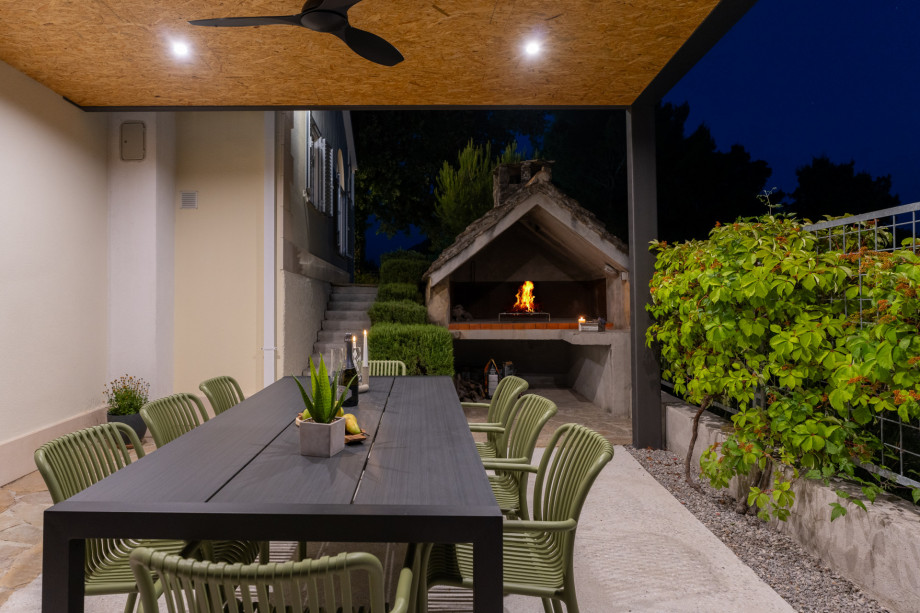 Outdoor covered dining area with a barbecue