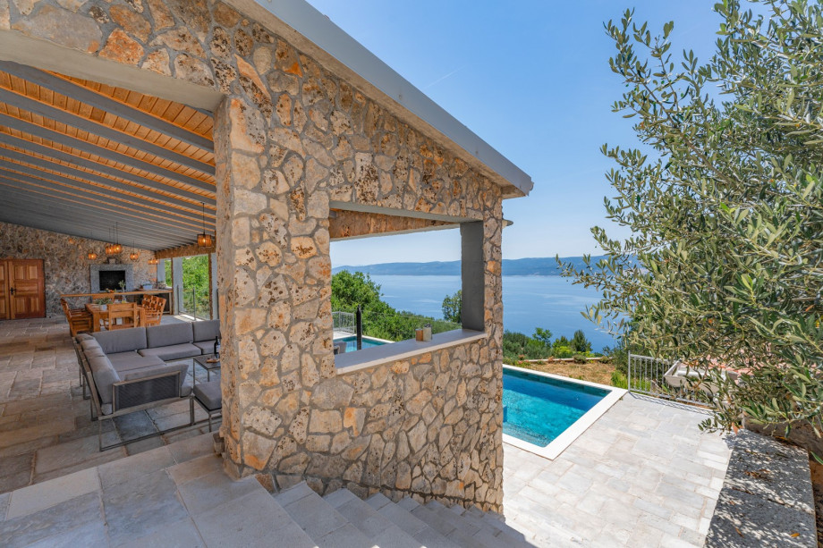 The pool is located on the lower position from the ground floor and the outdoor dining area.