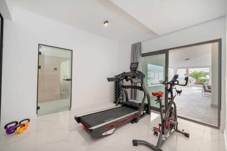 There is a Gym area (22 sqm) with a treadmill, exercise bike, a bench, and some weights and pilates equipment