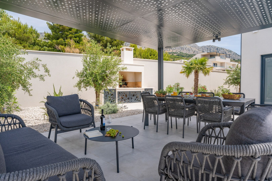 A covered dining area for 8 people with very comfortable chairs