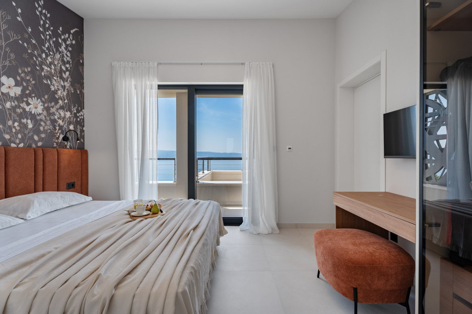 A television, air conditioning, and an en-suite bathroom with shower, and sea views.