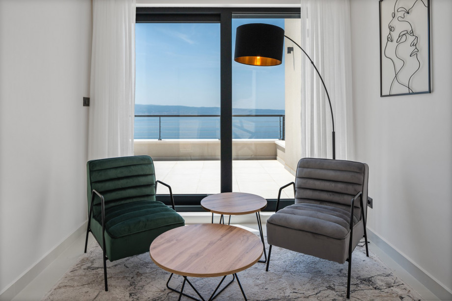 The first floor features a nice hallway with some sofas and an exit to a sea-view terrace