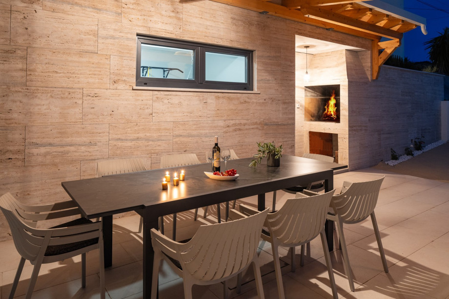 Covered outdoor dining area next to the summer kitchen