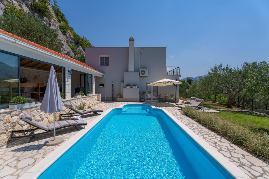 Sun deck area with 4 deck chairs and private pool