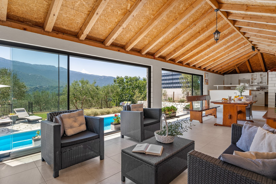 Fully equipped summer kitchen with barbecue and covered area for dining and sitting