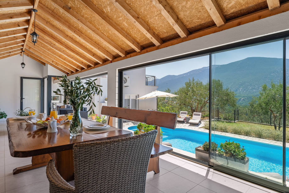 Fully equipped summer kitchen with barbecue and covered area for dining and sitting