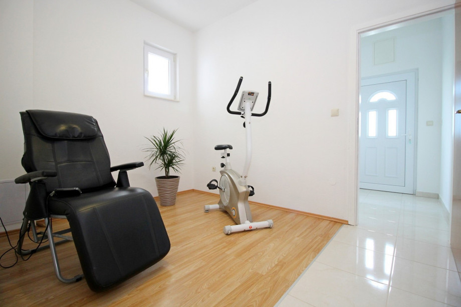 room with massage chair and exercise bike on the ground floor