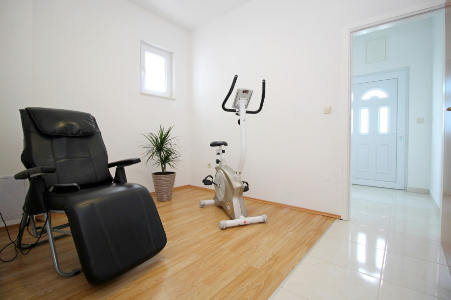 room with massage chair and exercise bike on the ground floor