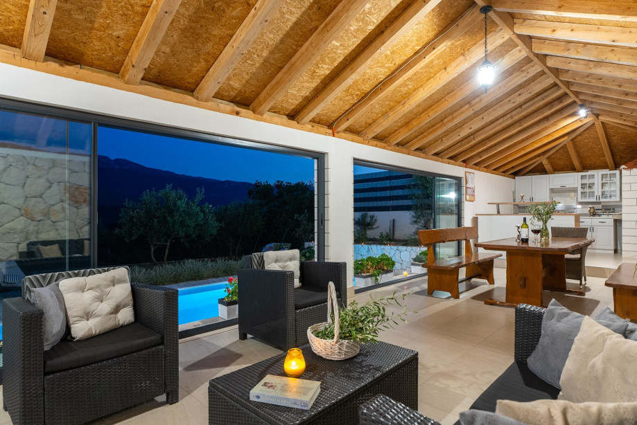 Fully equipped summer kitchen with barbecue and covered area for dining and sitting