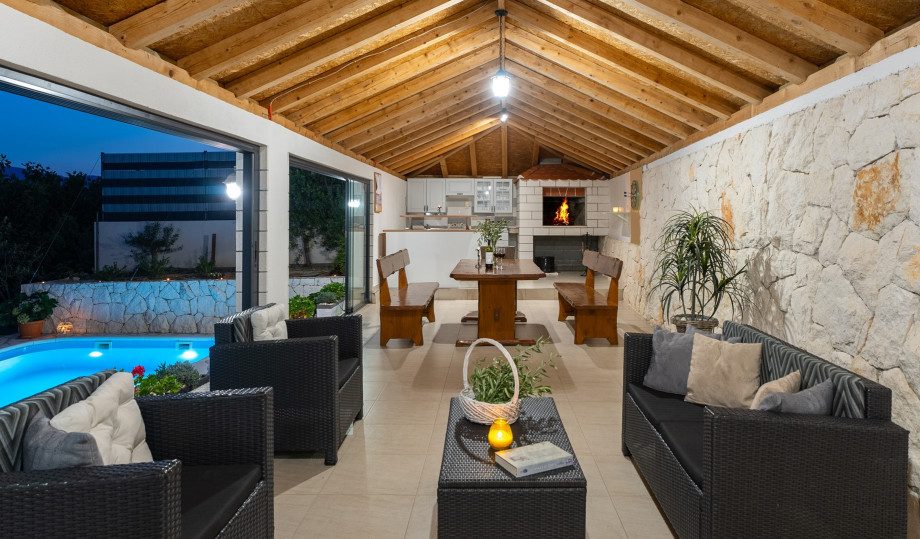 Fully equipped summer kitchen with barbecue and covered area for dining and sitting