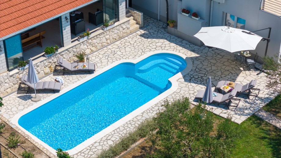 Sun deck area with 4 deck chairs and private pool