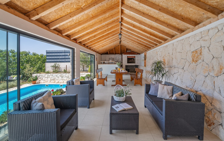 Fully equipped summer kitchen with barbecue and covered area for dining and sitting