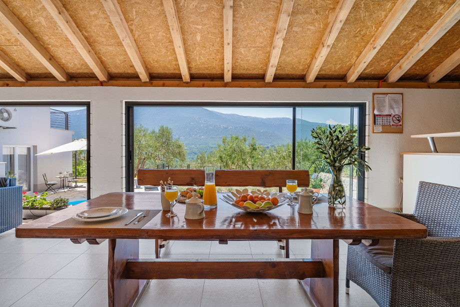 Enjoy the outside dinning area with great natural and pool view