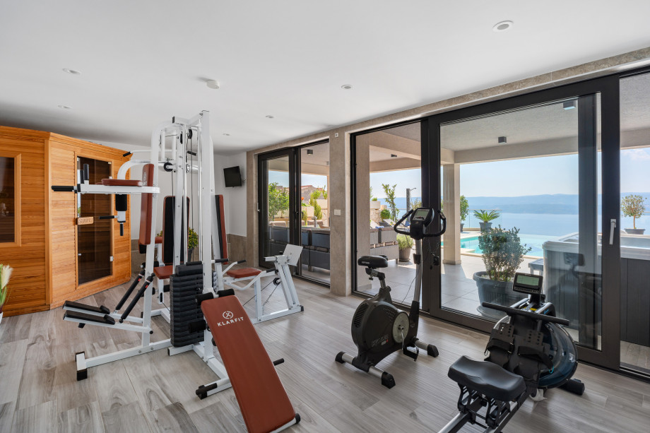 At pool level is a Sauna and a Gym with an exercise bike, a multifunctional machine, and rowing machine