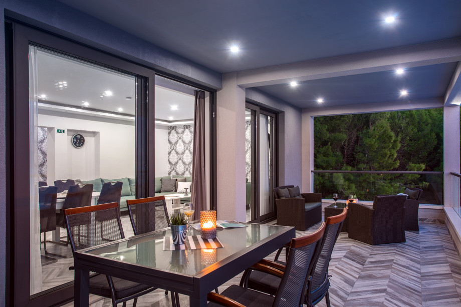 Spacious terrace in front of the living room with dinig table and lounge corner