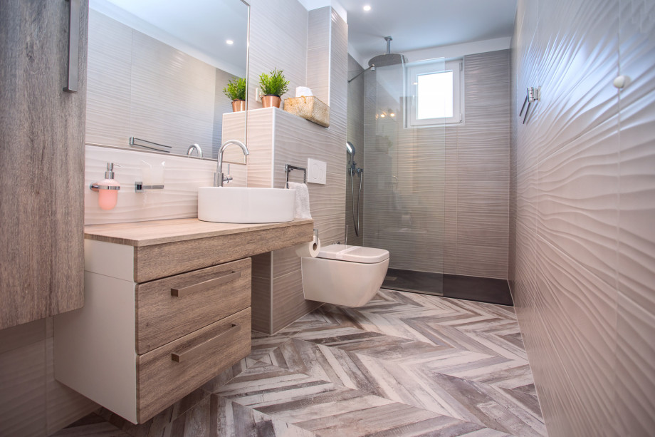 An en-suite bathroom with a shower, a sink, and a toilet