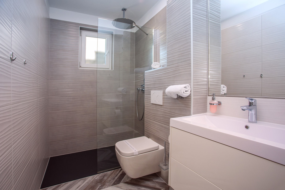 Bathroom with walk-in shower, sink and toilet
