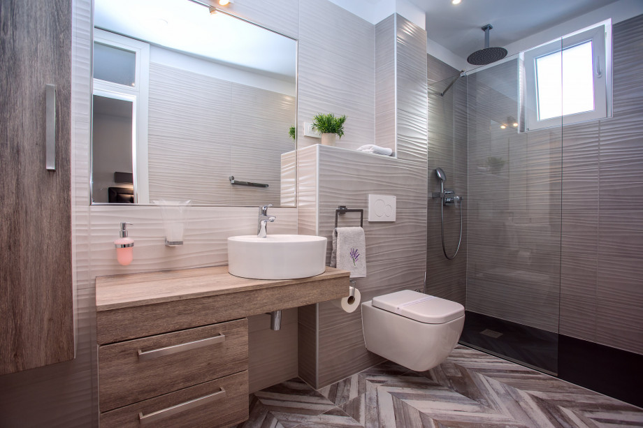An en-suite bathroom with a shower, a sink, and a toilet connected to bedroom No.4