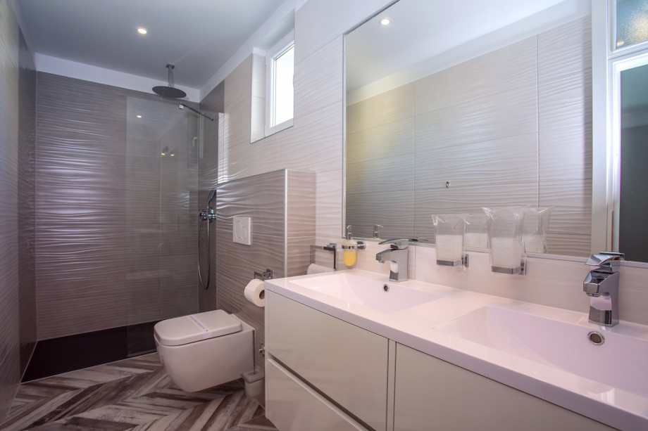 An en-suite bathroom with a shower, a sink, and a toilet connected to bedroom No.6