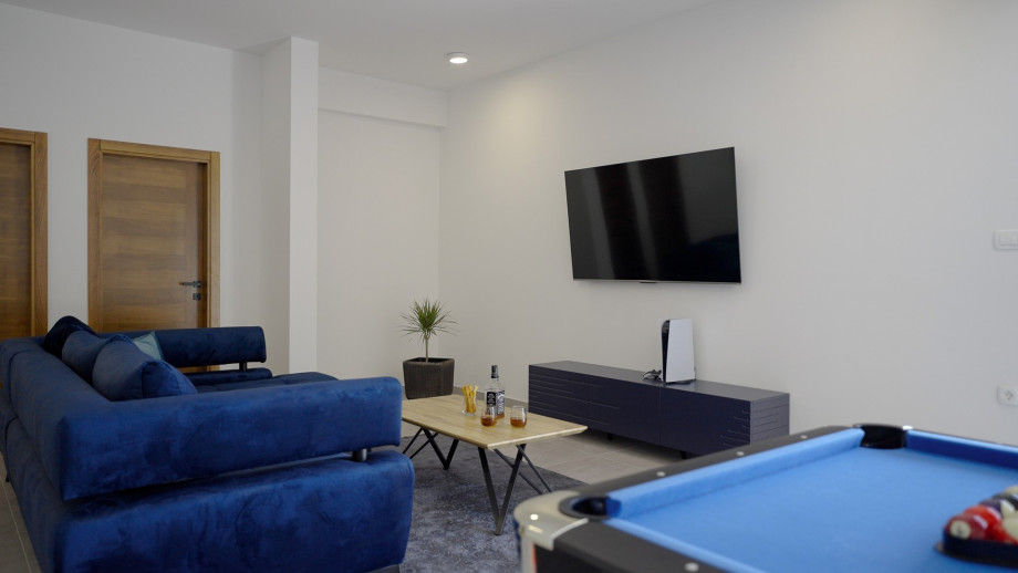 A/C FUN zone with a sofa (can convert into sofa bed), a flat screen TV, a PlayStation 5, a Billiards (Pool table), a Table tennis, and a separate toilet.