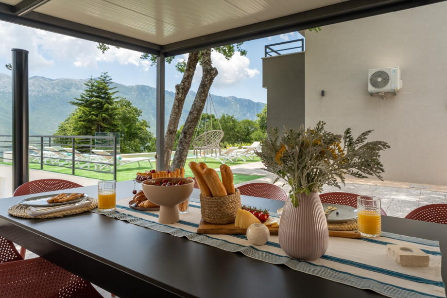 Next to it is a covered outdoor dining area with the traditional barbecue
