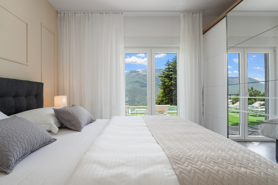 Bedroom No1 with doors toward the pool area