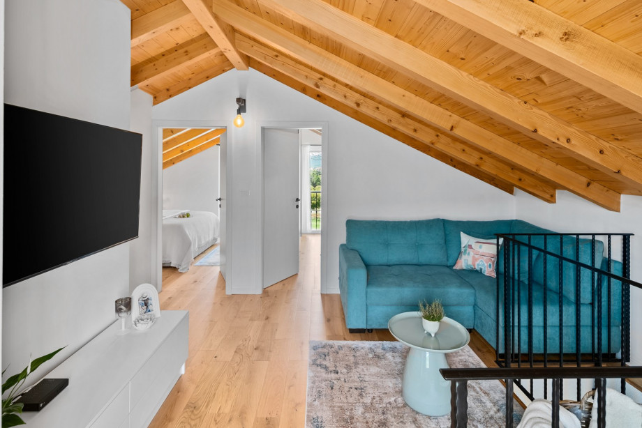 The first floor offers a gallery with a sofa (which can be converted into a sofa bed for two kids or one adult) and a TV.