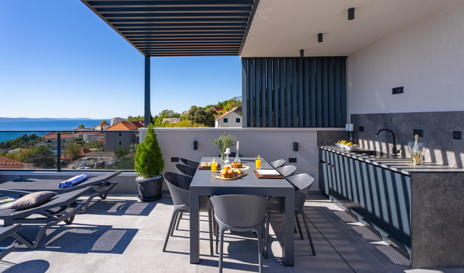 There exists a summer kitchen, outdoor dining area, and distinct restroom facility