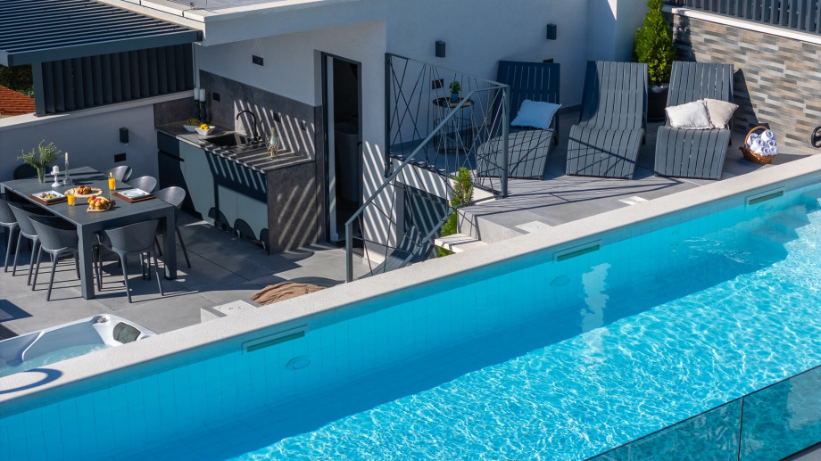 Rooftop terrace with a 40,7sqm heated pool, whirlpool, lunge chairs, and outdoor shower