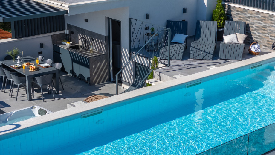 Rooftop terrace with a 40,7sqm heated pool, whirlpool, lunge chairs, and outdoor shower