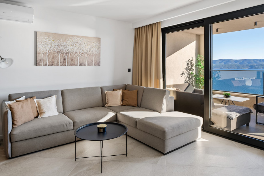 Stylish living room with sofa, flat screen TV, sliding doors to the covered 28sqm terrace