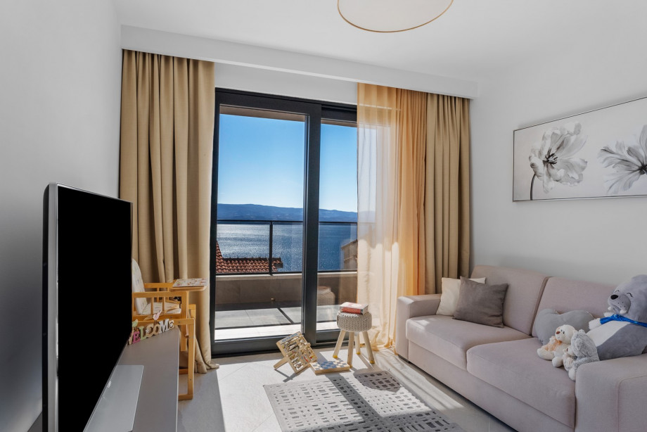 Area for children with a sofa, flat-screen TV, PlayStation 4, and many other toys